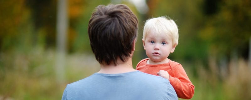 representing men. man holding young blond child